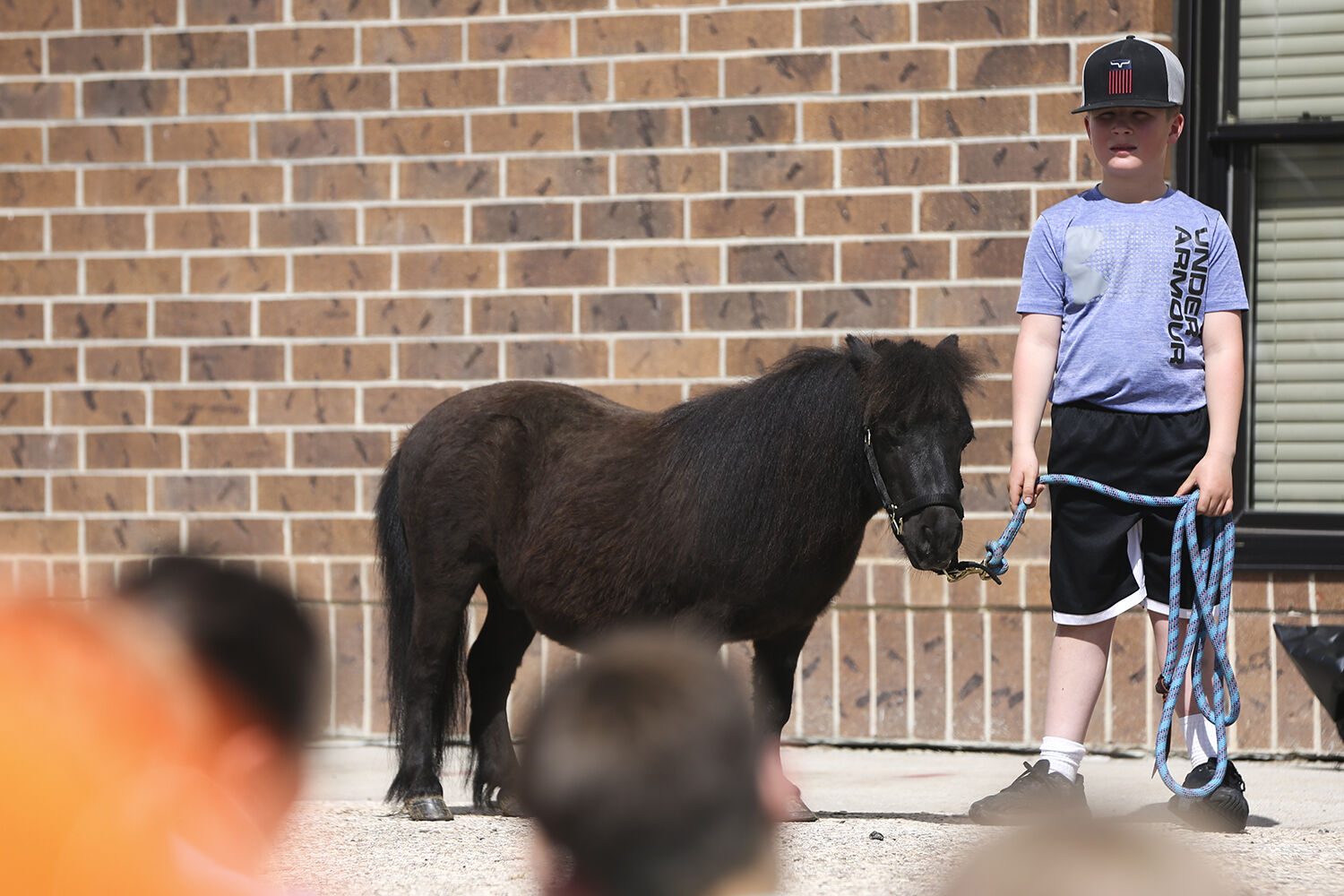 Kreyton Stotlz holds Hank the Mustang